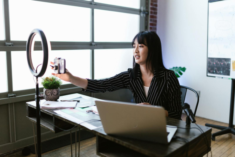 smartphone and ring light in office for content creation.